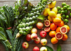 a group of fruits and vegetables on a wood surface Healthy Weight Loss Diets London