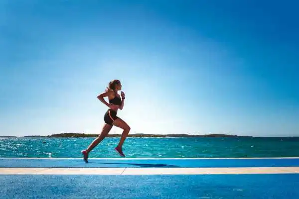 Woman running showing strong leg muscle London